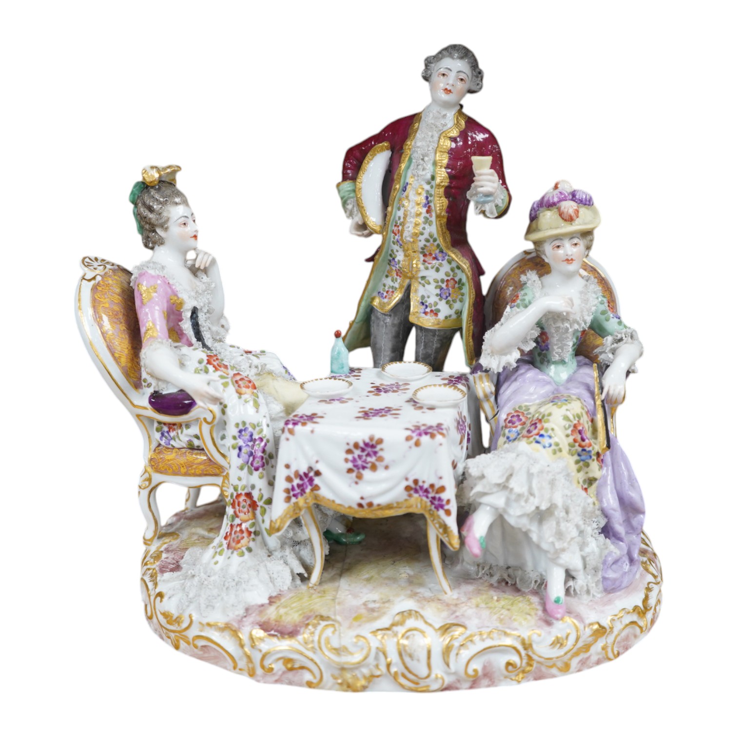 A large German porcelain ‘Tea Party’ group, 25cm high. Condition - has broken and been re-glued